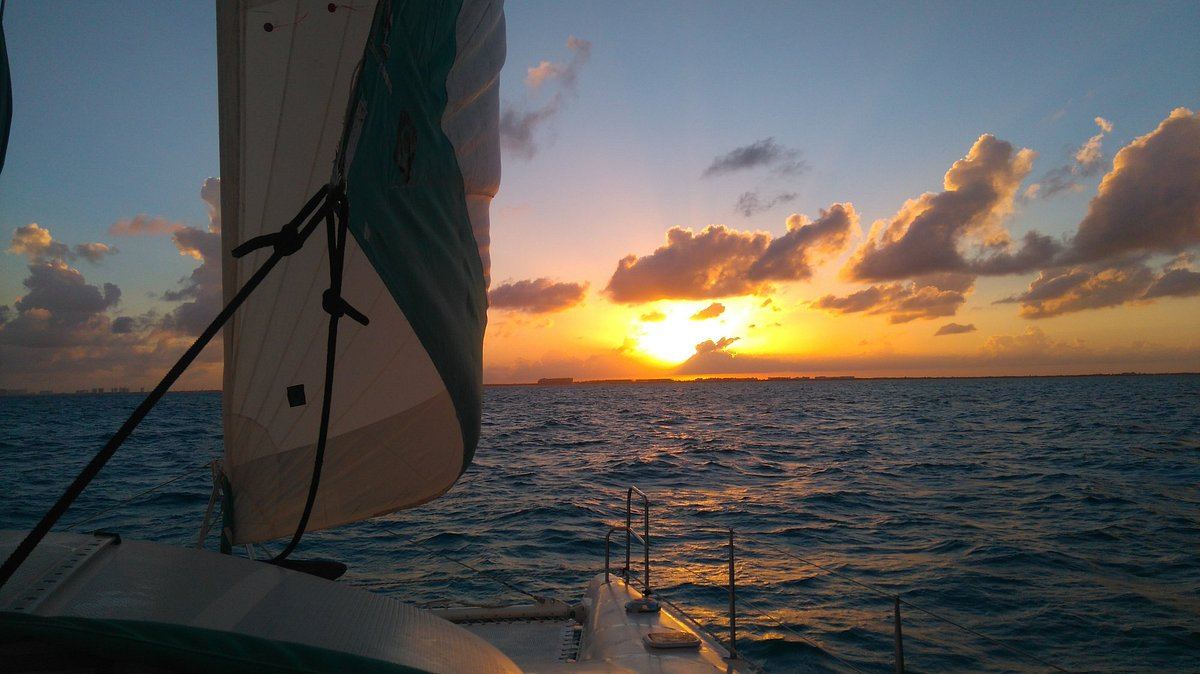 Sunset over the bay seen from the catamaran bow