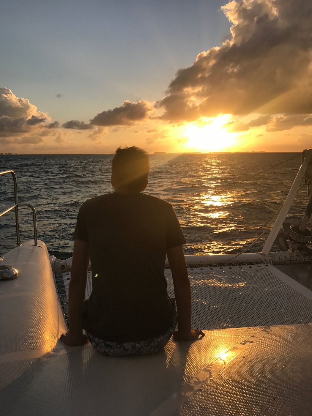 Silhouette watching the sunset from the bow