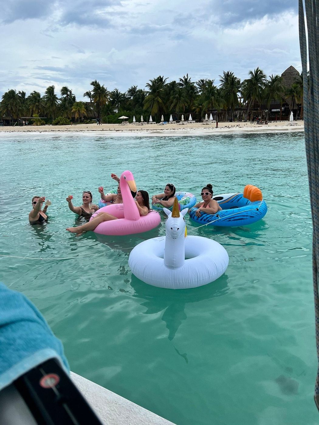 Floaties in clear turquoise water by the beach