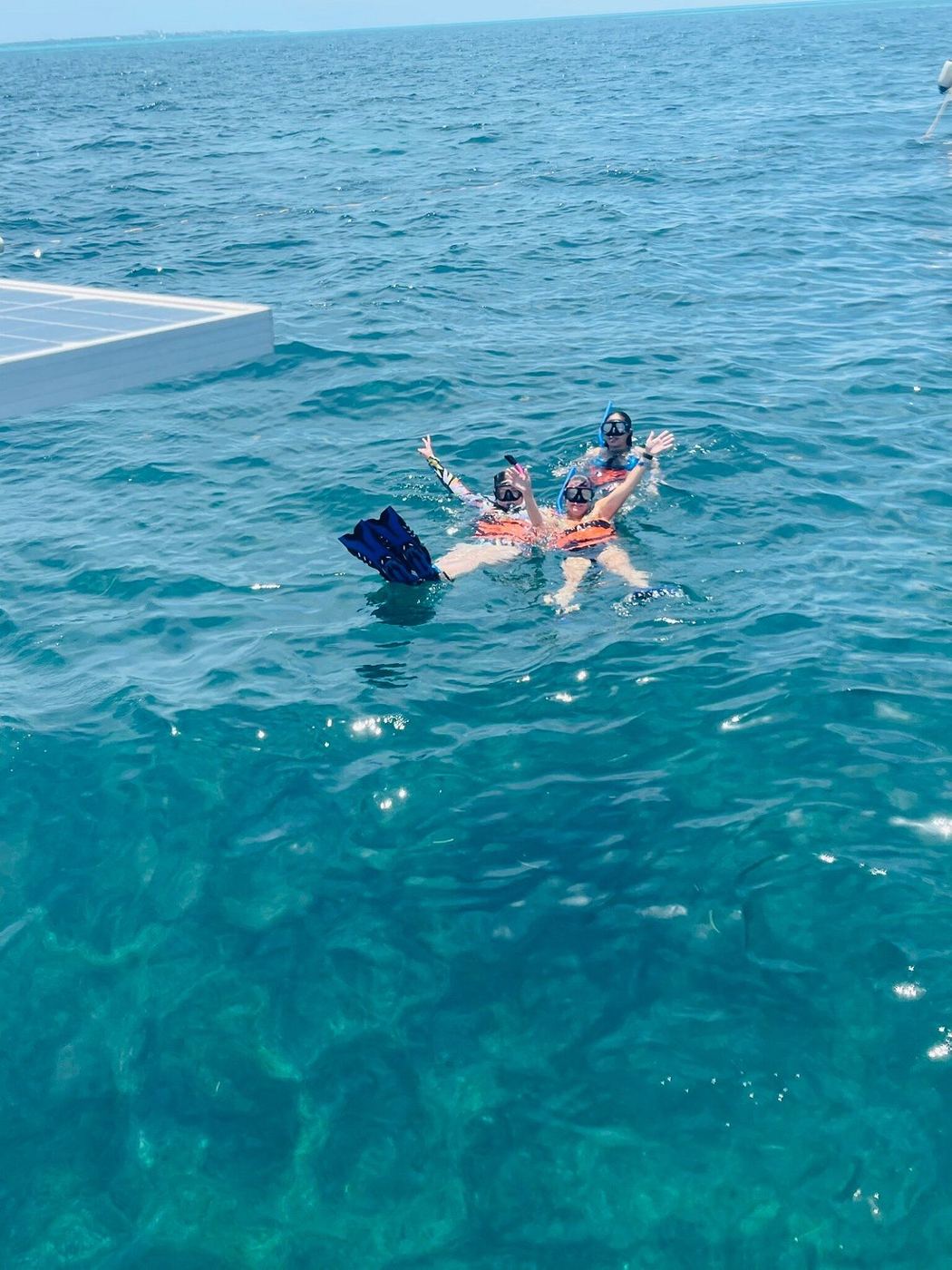 Swimmers seen from above in turquoise water